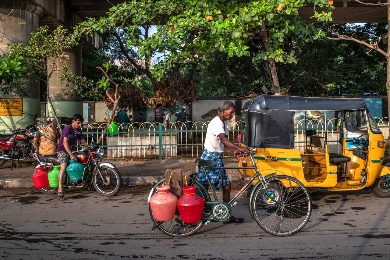 Residents leave after collecting water from pipes underneath a flyover in Chennai, India on June 25, 2019.