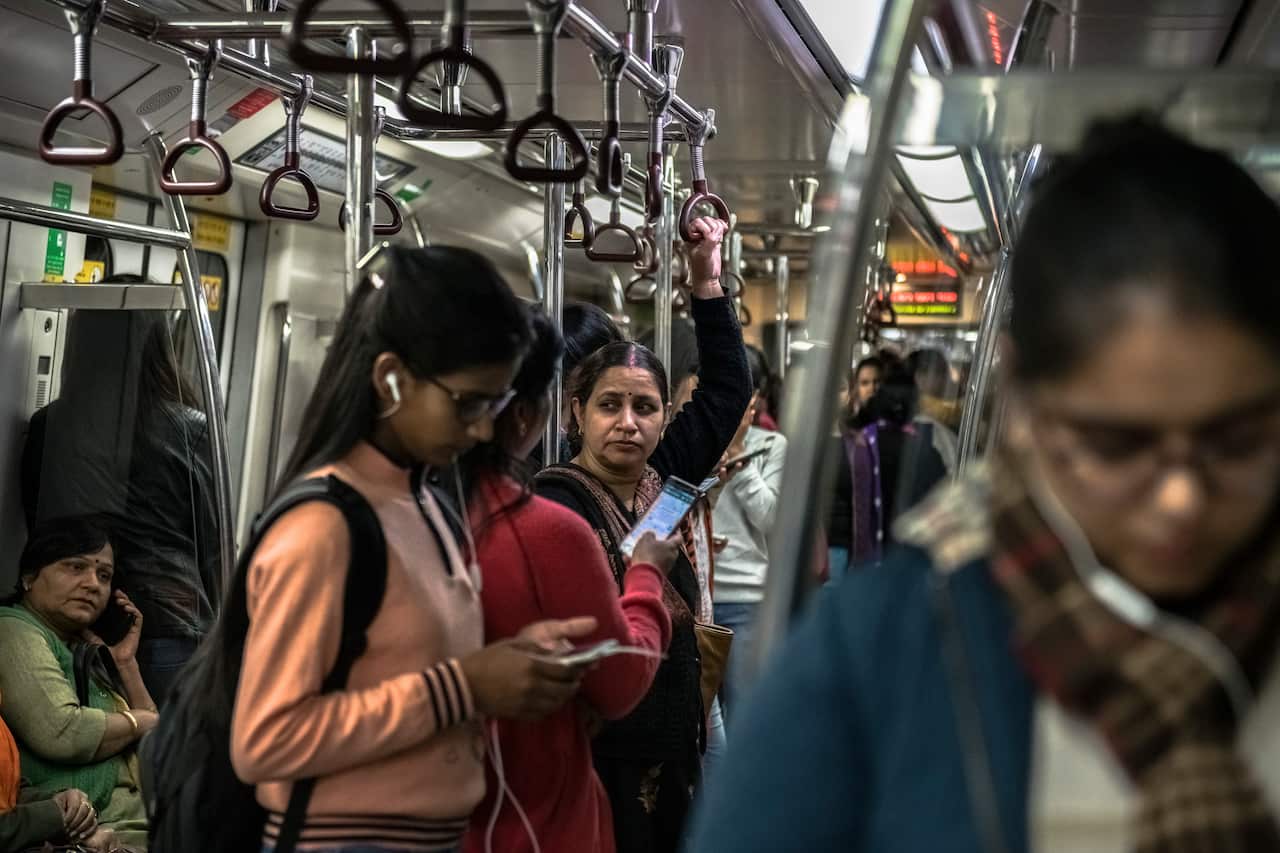 Commuters aboard a women-only subway car, in New Delhi, India.