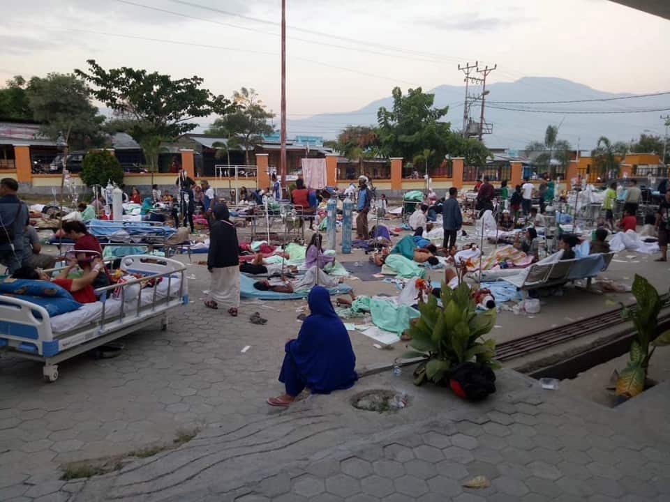 Indonesians gather outside Undata hospital.
