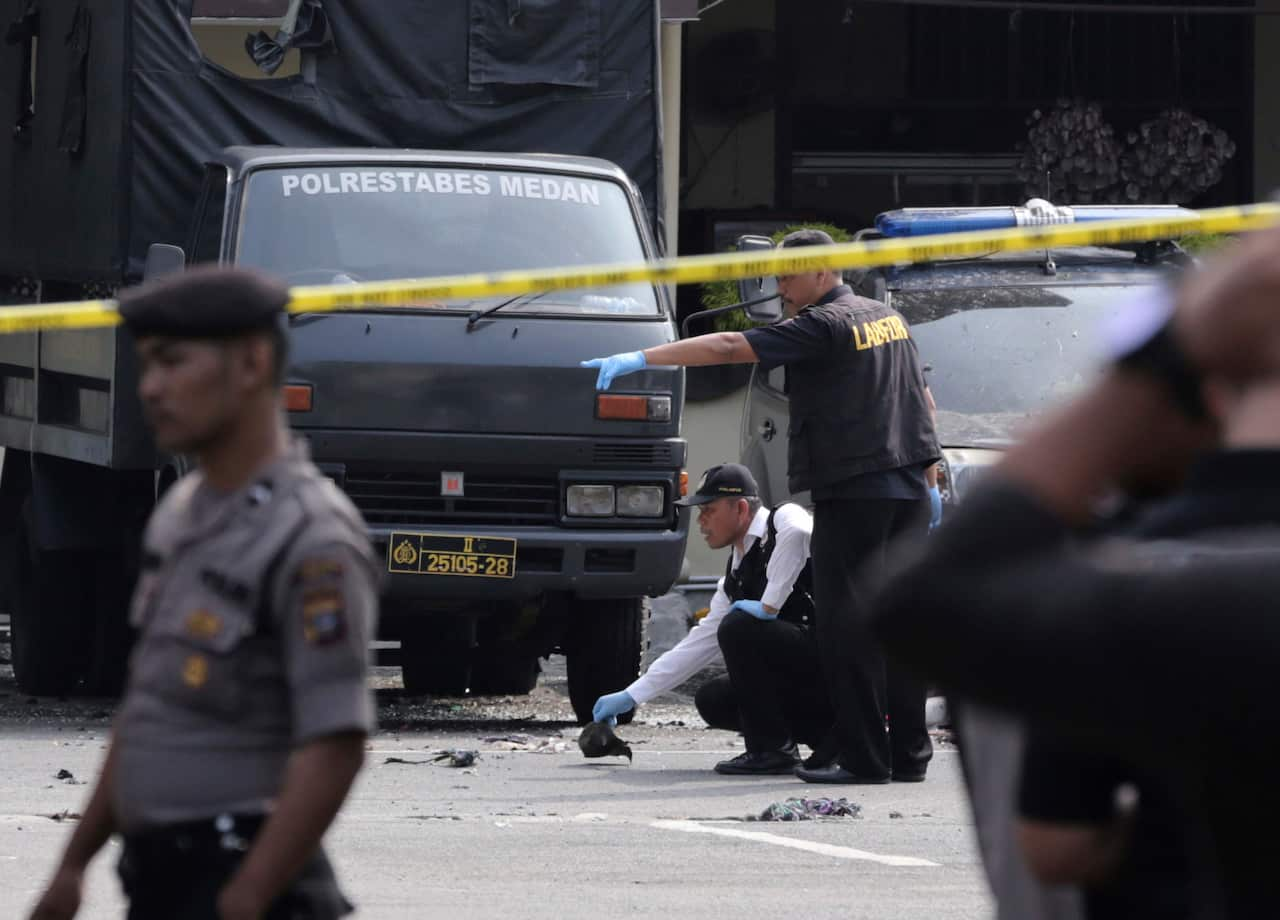 Members of police forensic team inspect the site.