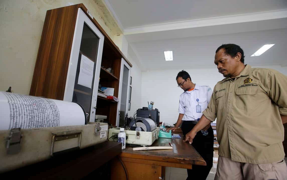 An official monitors a seismograf as the no-go zone around an island volcano that triggered a tsunami on the weekend is widened.