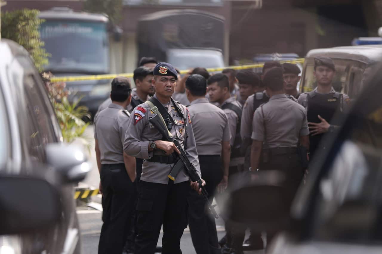 A police officer stands guard near the site of the bombing attack at the local police headquarters.