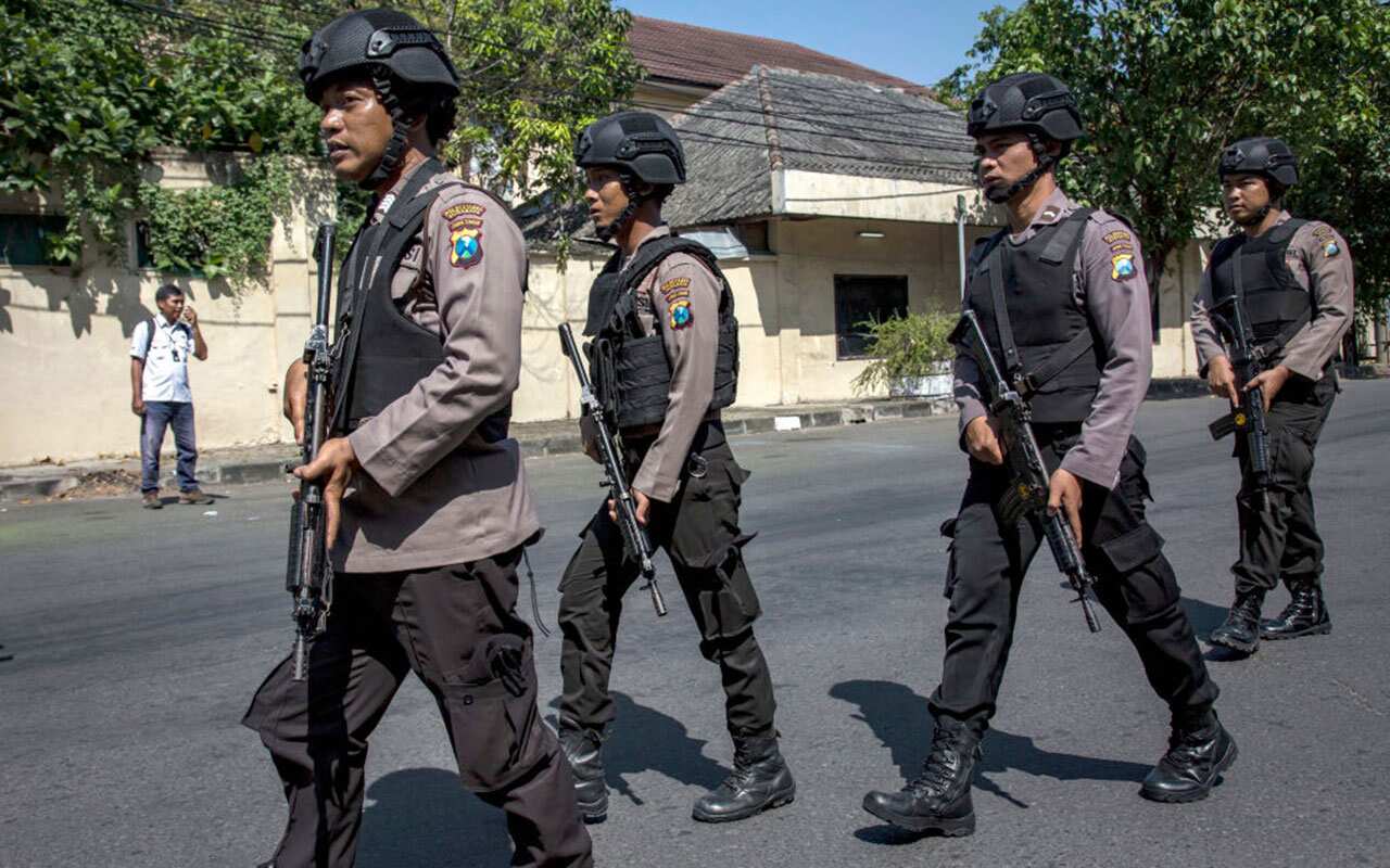 Indonesian police outside a police station in Surabaya.