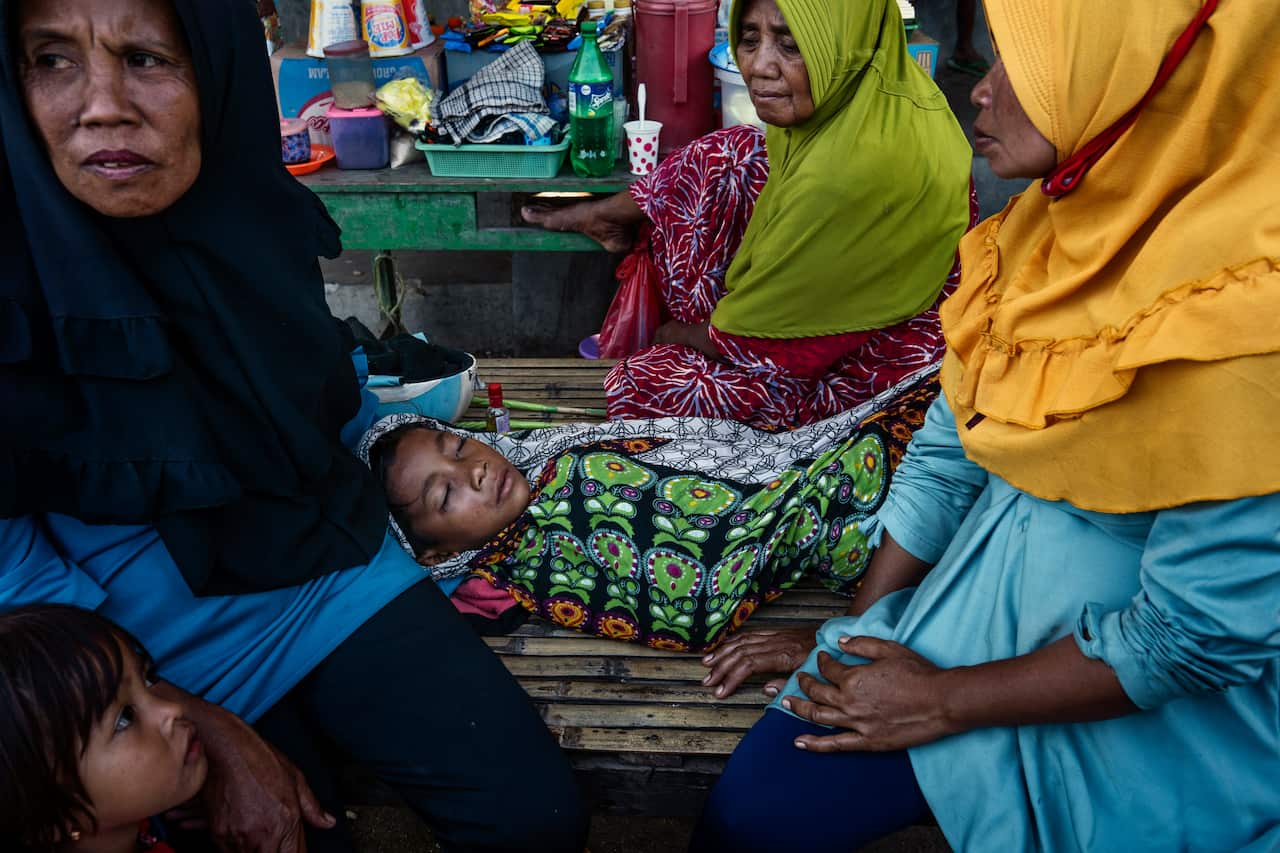 Imam Dudu, 8, rests after falling from his mount during a horse race in Bima, on the Indonesian island of Sumbawa, where child jockeys are a longstanding tradition. (Adam Dean/The New York Times)