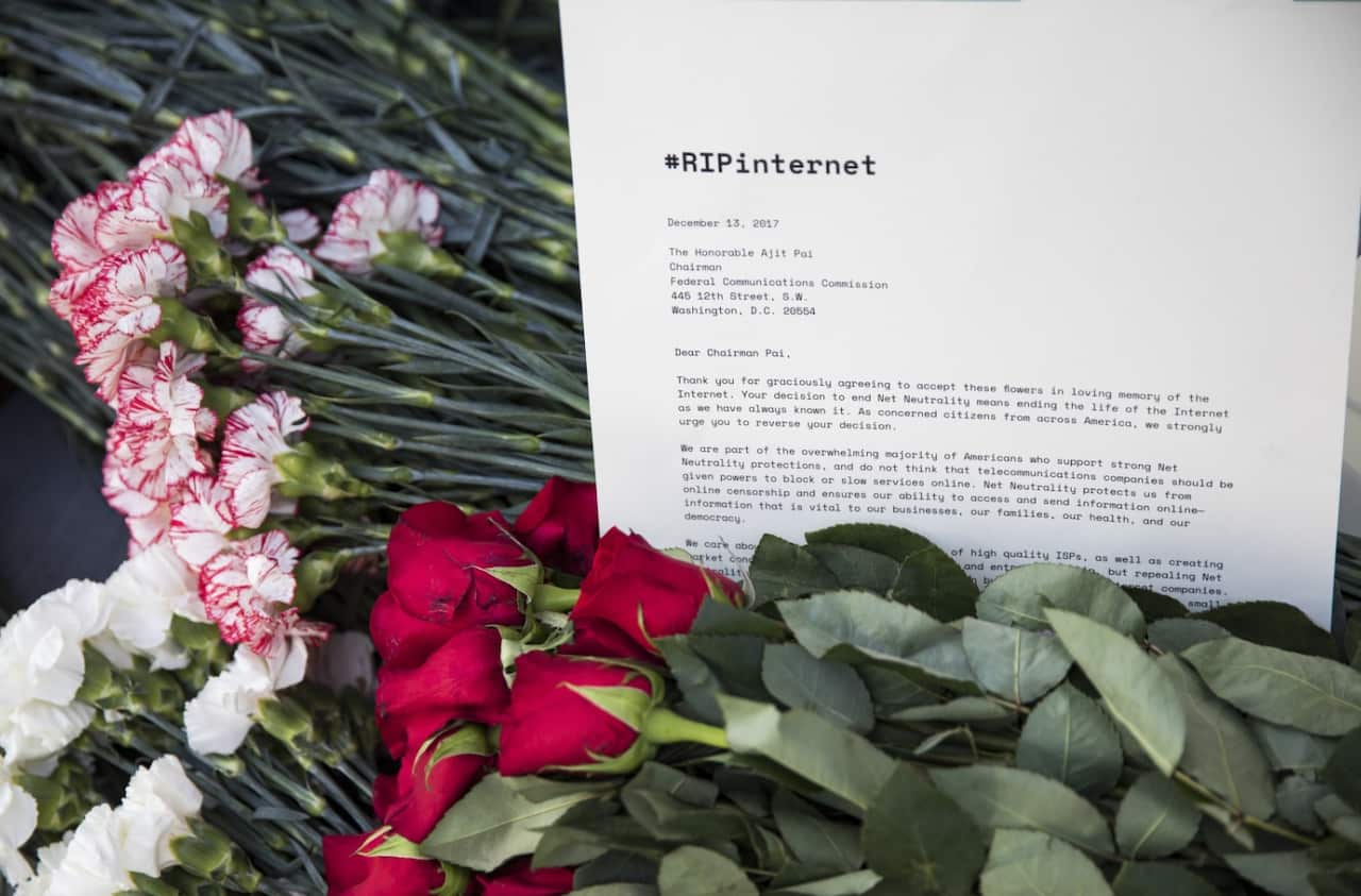 Protesters laid flowers and notes outside of the Federal Communications Commission (FCC) headquarters after the FCC repealed the Obama era regulations
