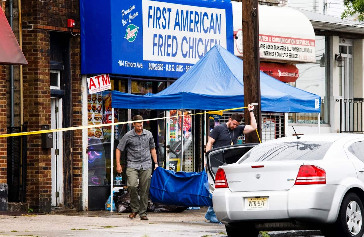 FBI investigators gather evidence at a business, First American Fried Chicken, owned by the family of Ahmad Khan Rahami (AAP)