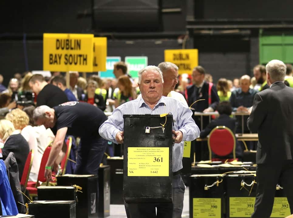 A man carries a ballot box after polls closed in the Irish referendum on the 8th Amendment of the Irish Constitution.