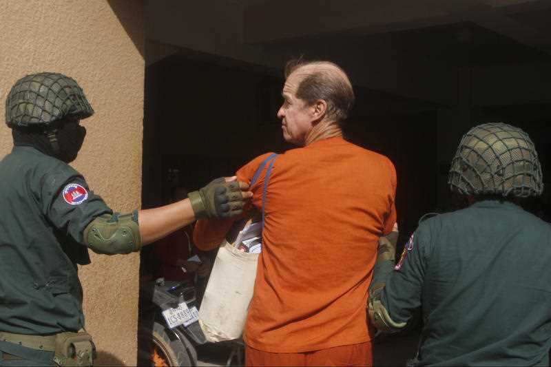 The Australian filmmaker is led into court for the final day of his trial.