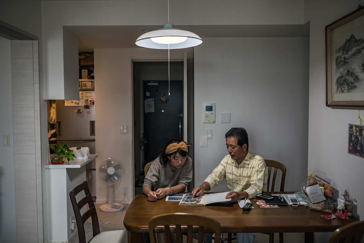 At his home in Tokyo in August 2018, Jiro Oshima and his granddaughter Misa An look through old photo albums of his trips to visit family in North Korea.