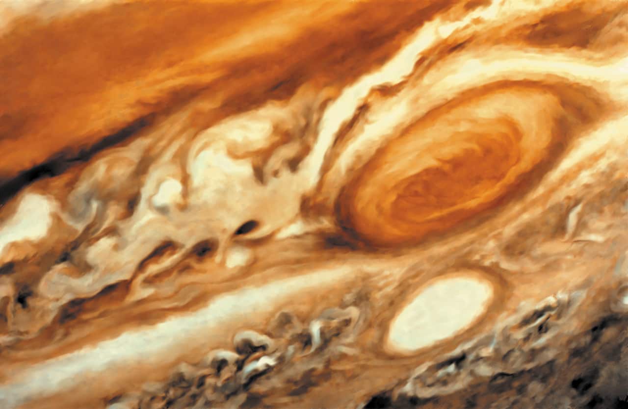 Jupiter's trademark Great Red Spot - a raging hurricane-like storm south of the equator.