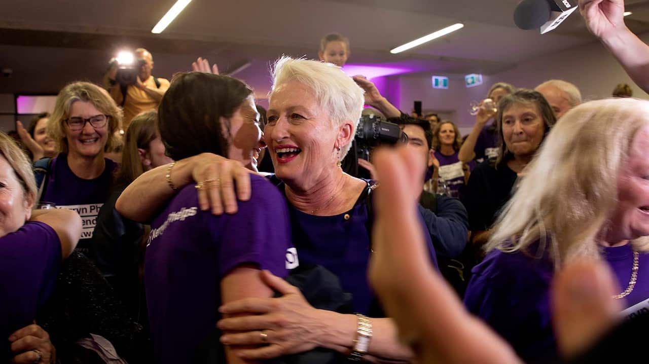 A victorious Kerryn Phelps celebrates with supporters after the election was called on Saturday night.