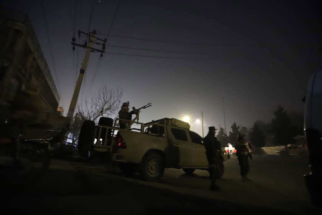 Afghan security officials take up positions near the scene of attack by armed men at the Intercontinental Hotel in Kabul.