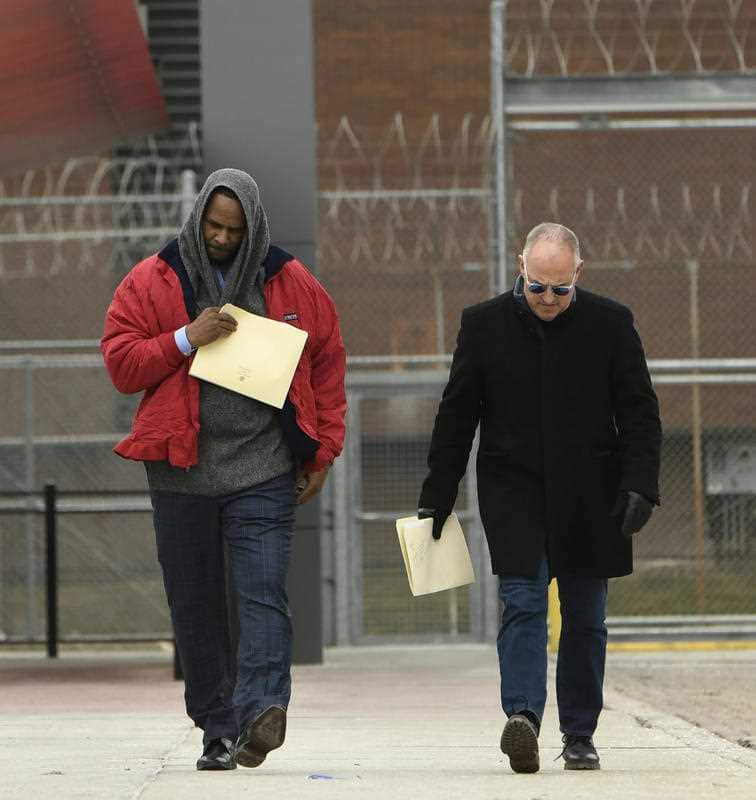 Singer R. Kelly left, walks with his attorney Steve Greenberg right, after being released from Cook County Jail.