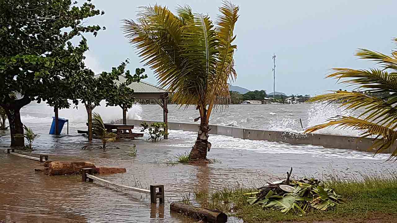 Water breaks over the sea wall in Saibai.