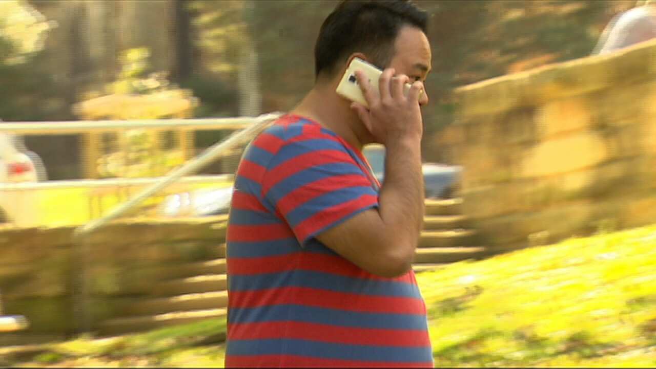 Terry Koo uses his smart phone.