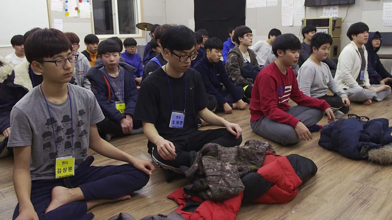 Chan Woo (centre of image) takes part in a meditation centre at the camp.