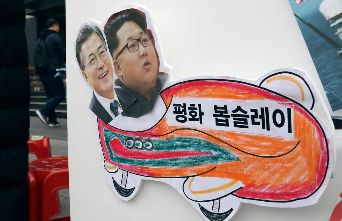 Pictures of South Korean President Moon Jae-in and North Korean leader Kim Jong Un on a sign during a rally to denounce the US policy towards the north.