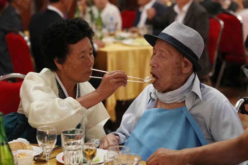 A father-daughter reunion after six decades: South Korea's Ahn Jong-ho, 100, is fed by his 70-year-old daughter Ahn Jung-soon.