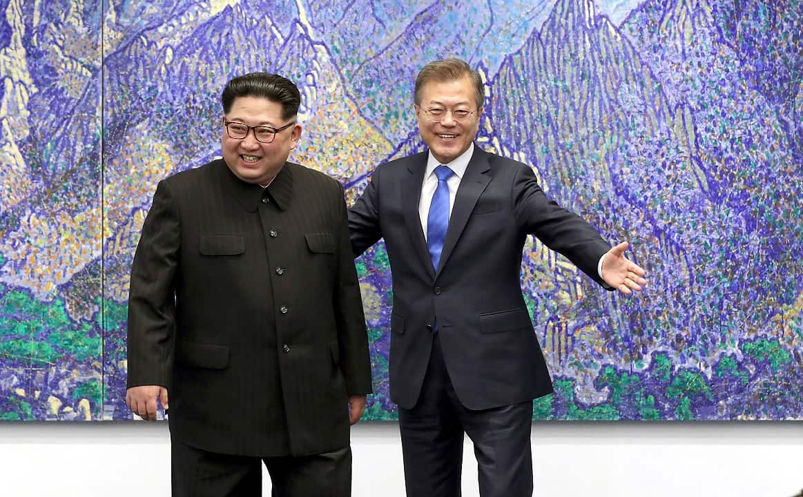 North Korean leader Kim Jong Un, left, is escorted by South Korean President Moon Jae-in inside the Peace House at the border village of Panmunjom.