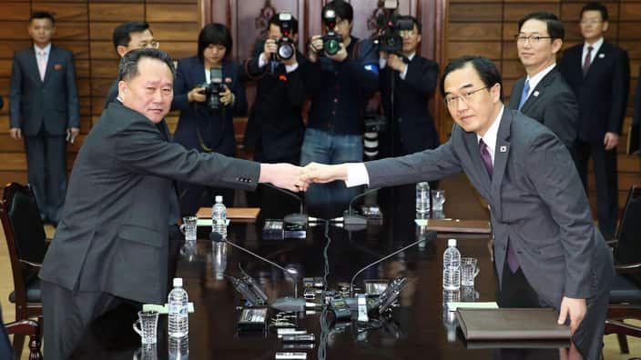 South Korean Unification Minister Cho Myoung Gyon (R) and Ri Son Gwon, chairman of North Korea's Committee shake hands.