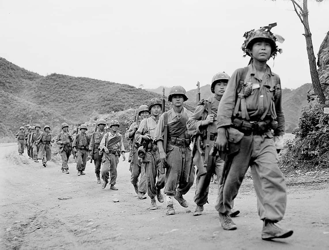 Republic of Korea (ROK) soldiers move in single file toward Korea's east-central front near Lookout Mountain, east of the Pukhan River, on June 28, 1953