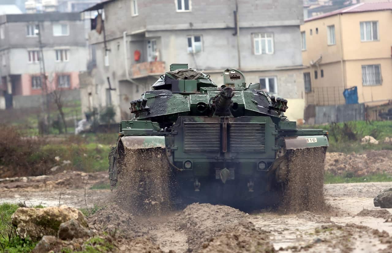 A Turkish army tank moves toward the Syrian border, in Reyhan