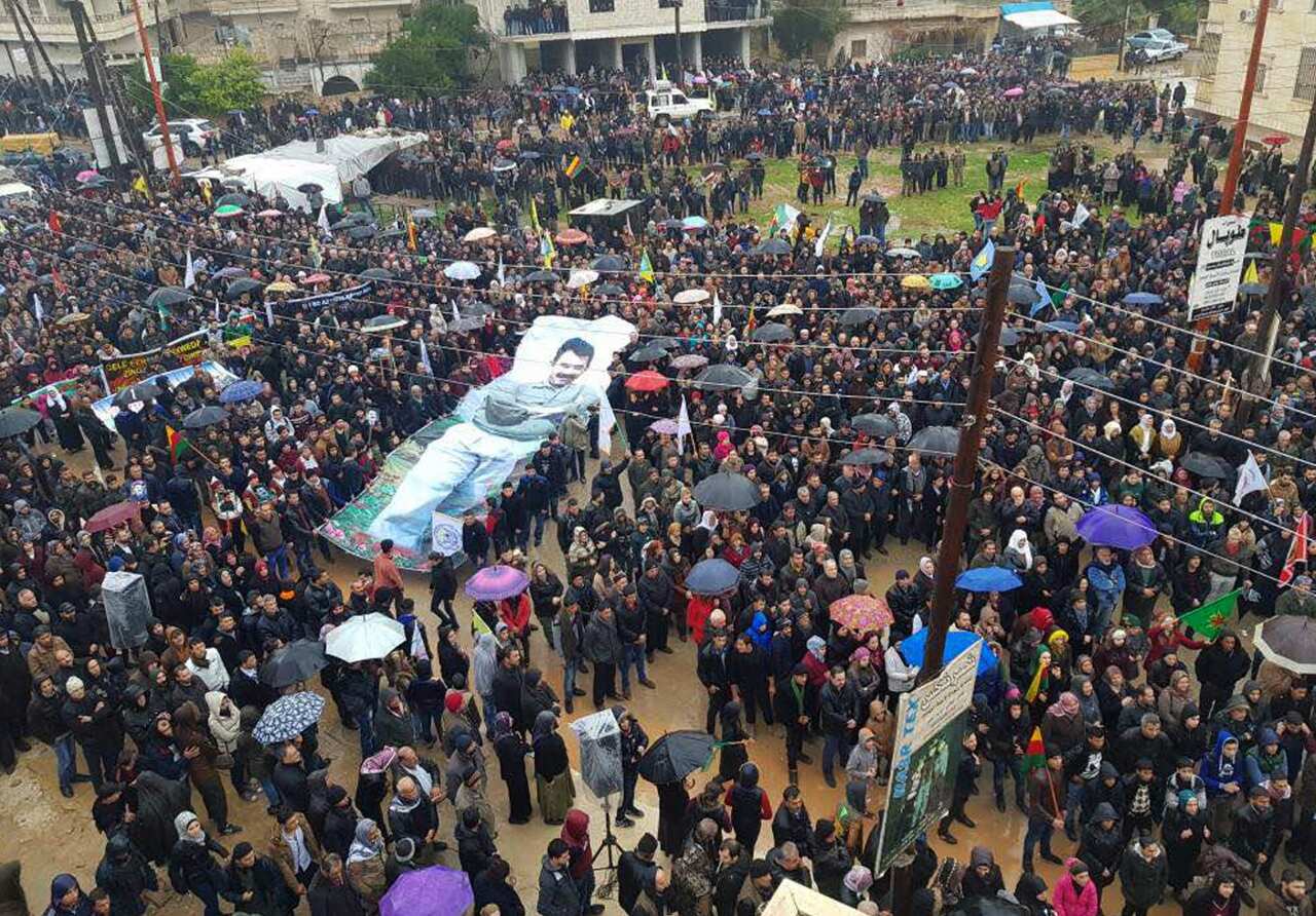 People's Protection Units or YPG protestors waving a giant poster of jailed PKK leader Abdullah Ocalan
