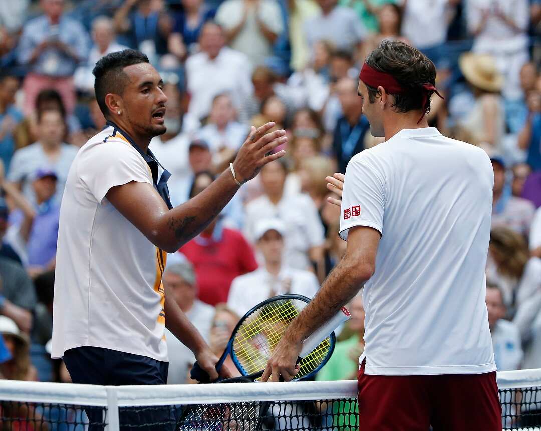 Roger Federer, right, of Switzerland, shakes hands with Nick Kyrgios, of Australia, after Federer defeated Kyrgios during the third round of the U.S. Open tennis tournament, Saturday, Sept. 1, 2018, in New York. (AP Photo/Jason DeCrow)
