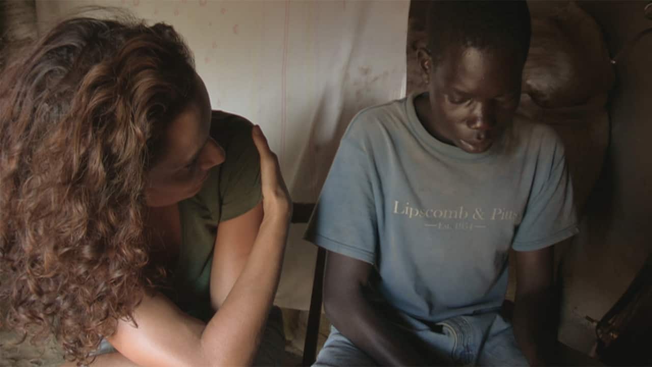 Kiki with Patrick before his first sign language lesson, when he was silent and withdrawn.