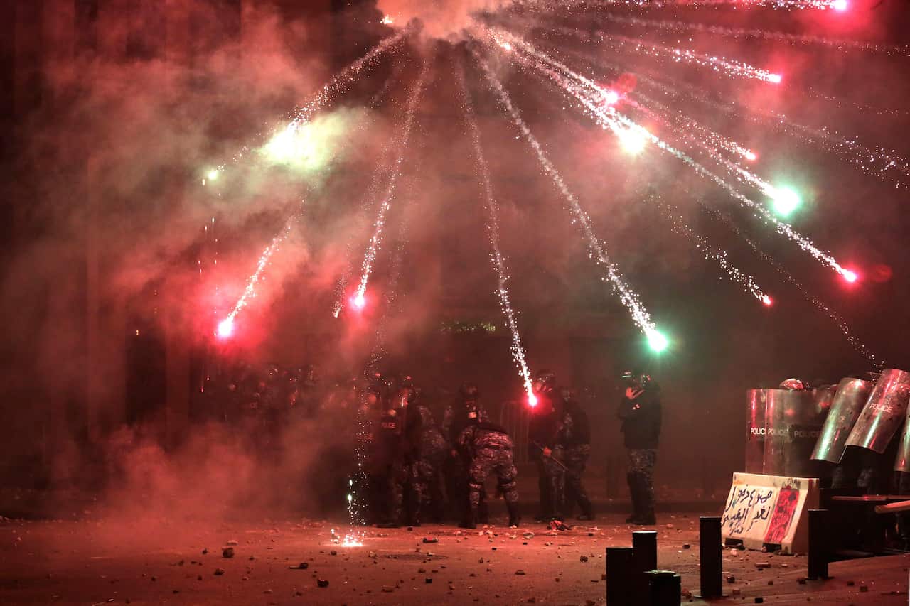 Anti-government protesters use fireworks against Lebanese riot police as part of the clashes.