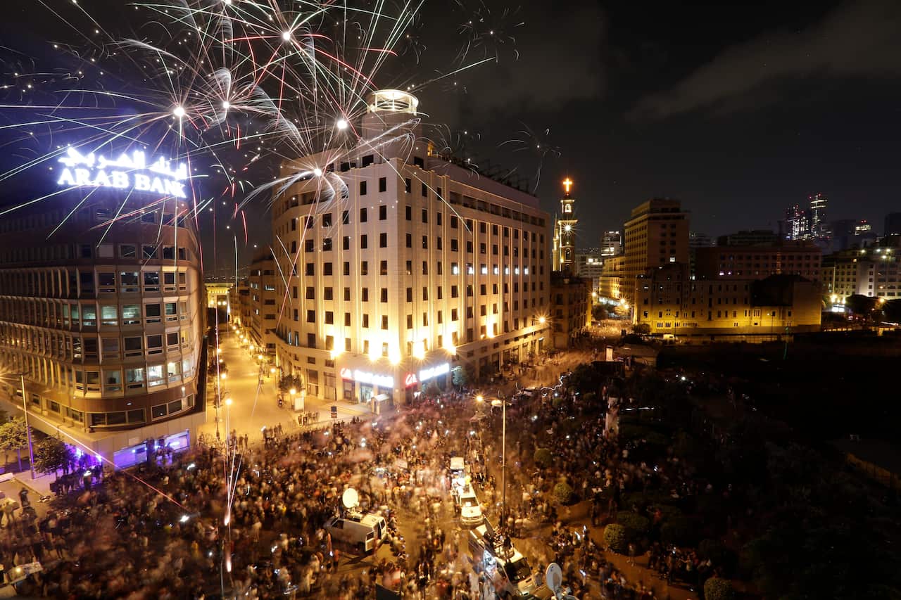 Hundreds of thousands thronged public squares across Lebanon on Sunday in the largest protests the country has seen since 2005.