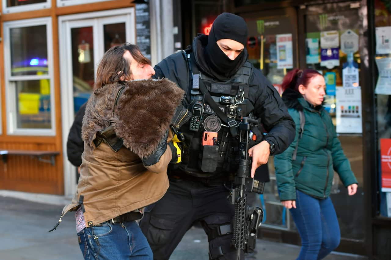 A police officer moves an uninvolved person away from the cordon around London Bridge, following the shooting.