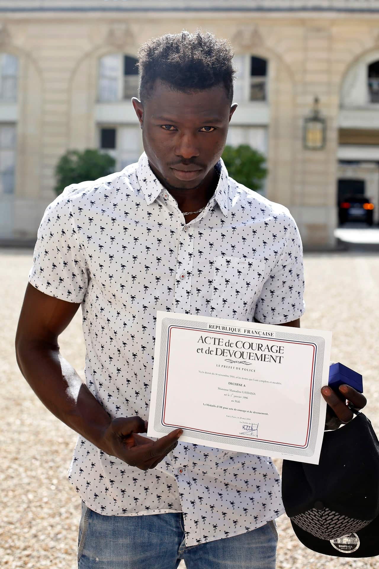 Mamoudou Gassama, 22, from Mali, displayed a certificate of courage and dedication signed by Paris Police Prefect Michel Delpuech.
