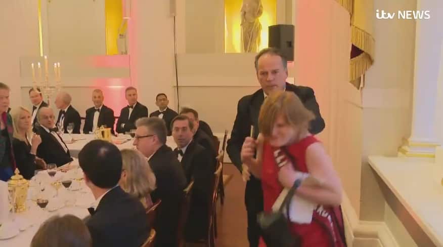 Video appears to show British MP Mark Field forcibly removing a climate protester from the official dinner.