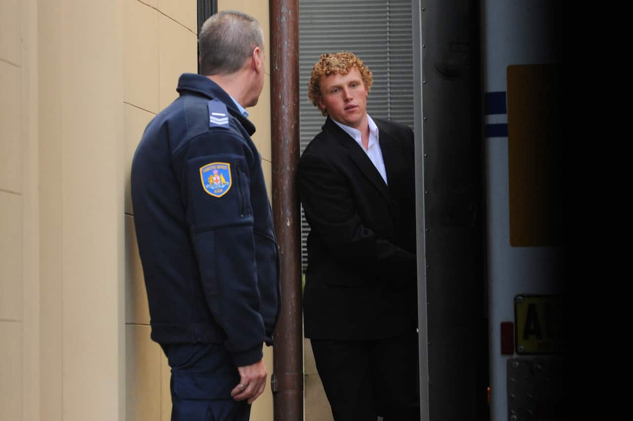 Matthew Milat, the great-nephew of Ivan Milat, is escorted from the King Street courts in 2012. Milat was sentenced to 43 years jail.
