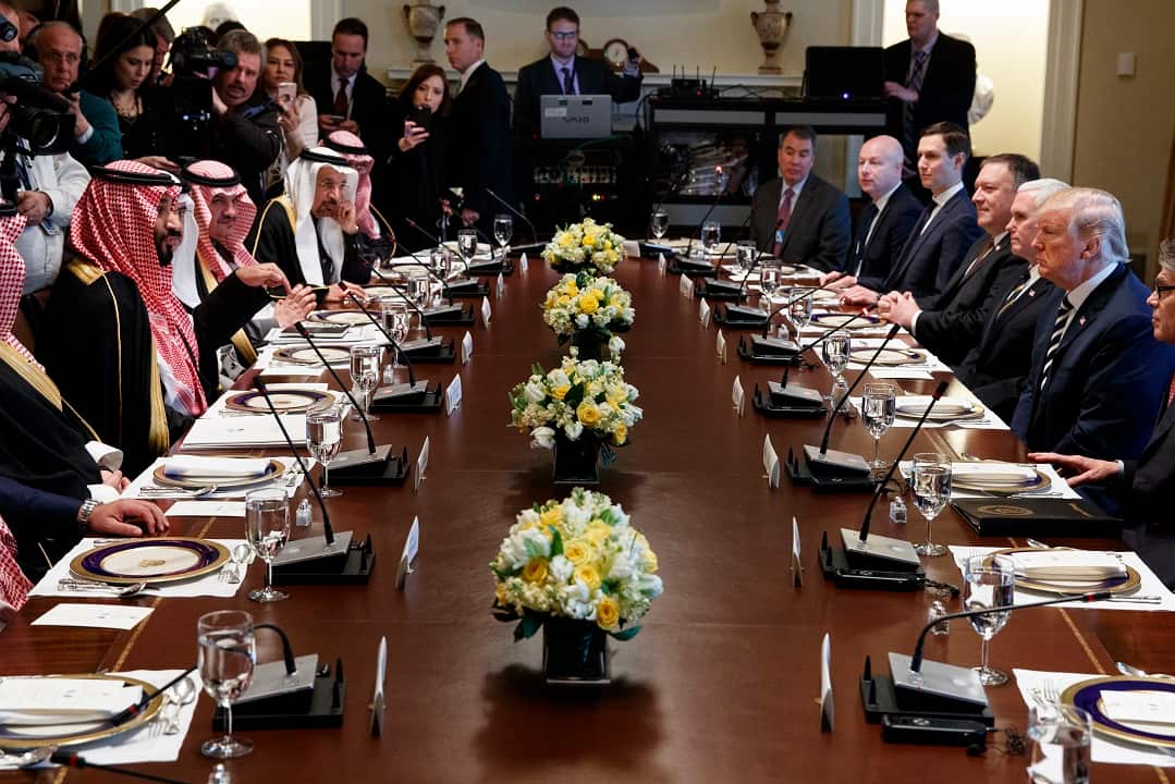 President Donald Trump listens as Saudi Crown Prince Mohammed bin Salman speaks during a working lunch.