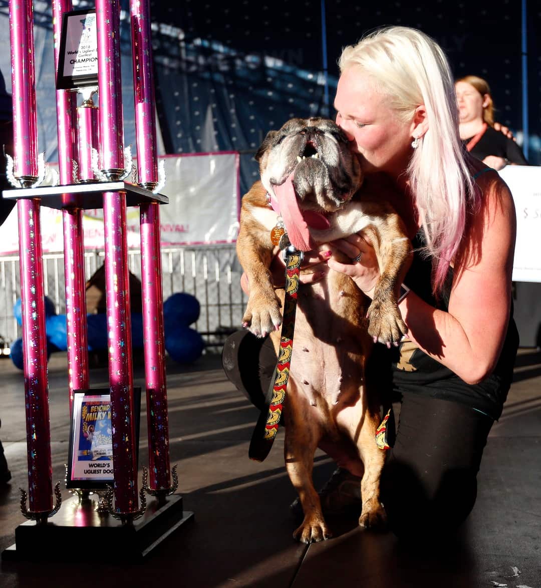 Megan Brainard kisses her dog Zsa Zsa.