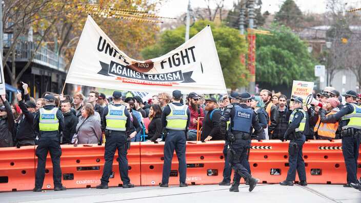 Police separate the two group of protesters at Parliament House.
