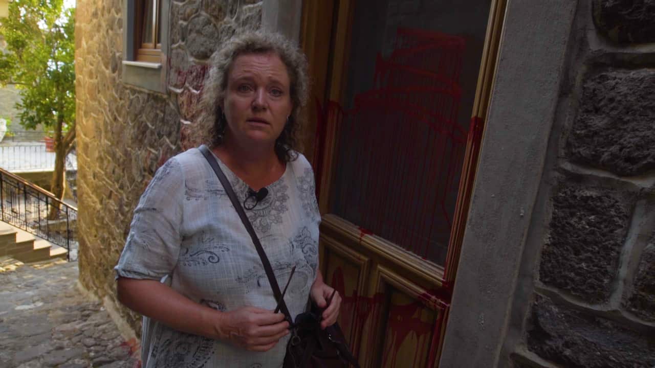 Melinda McRostie, an Australian-Greek restaurant owner and director of the NGO, Starfish Foundation, outside her recently vandalised property on Lesbos, Greece