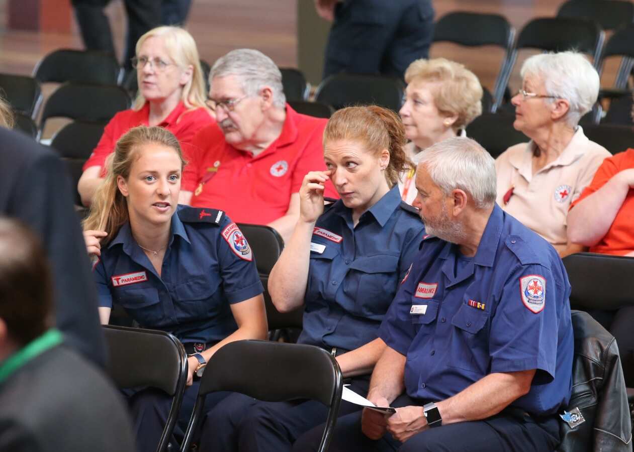 Emergency workers and the public at a public memorial service in the Melbourne Royal Exhibition building