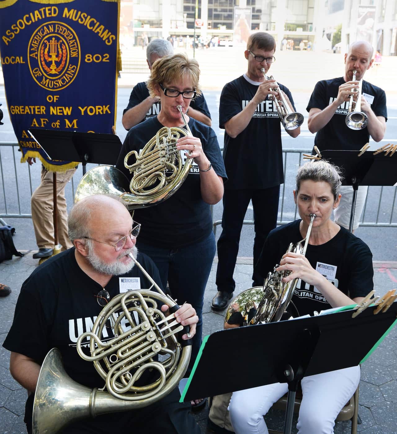 Members of the Metropolitan Opera orchestra play during a labor rally.