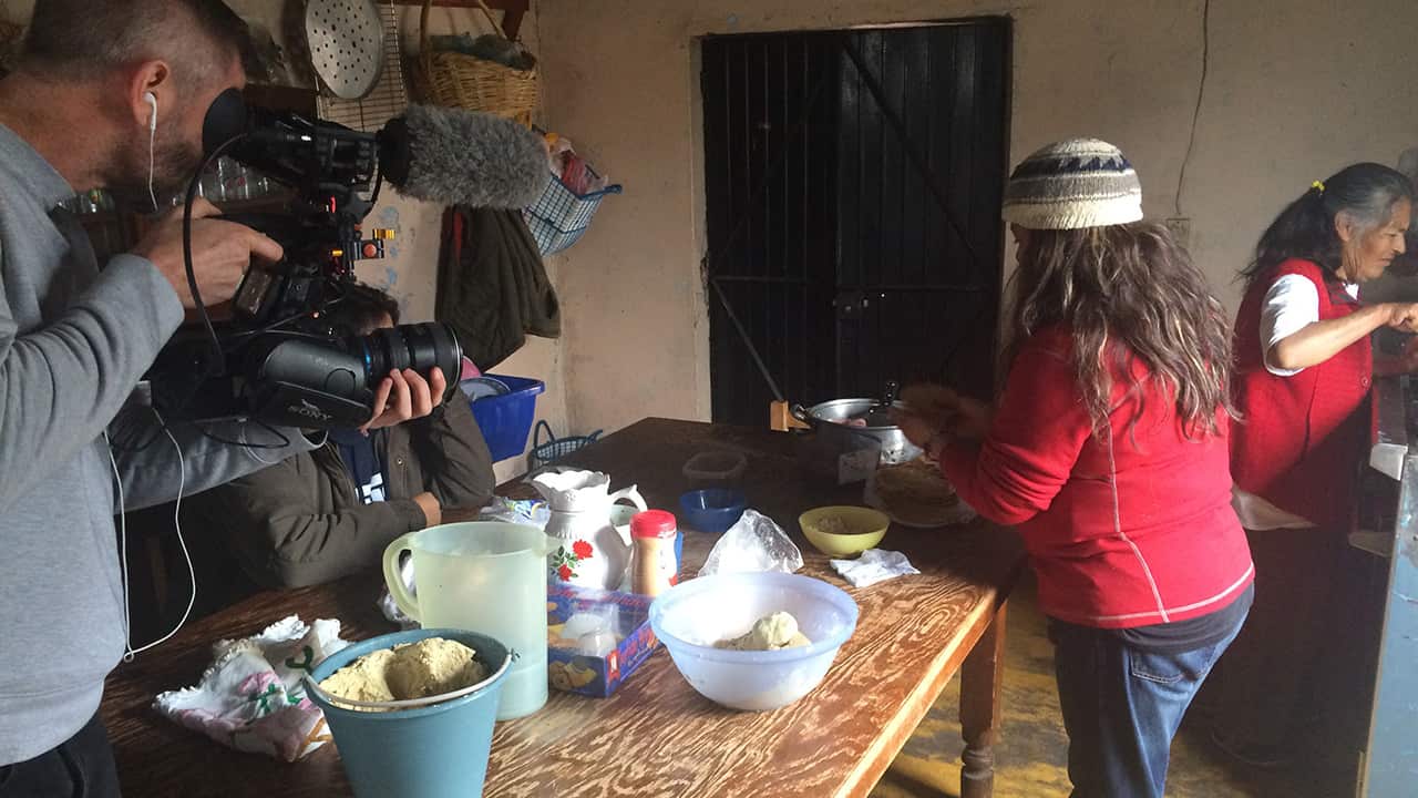 Rosa (centre) prepares another Mexican feast as Aaron films. She hasn't seen her two sons for 12 years.