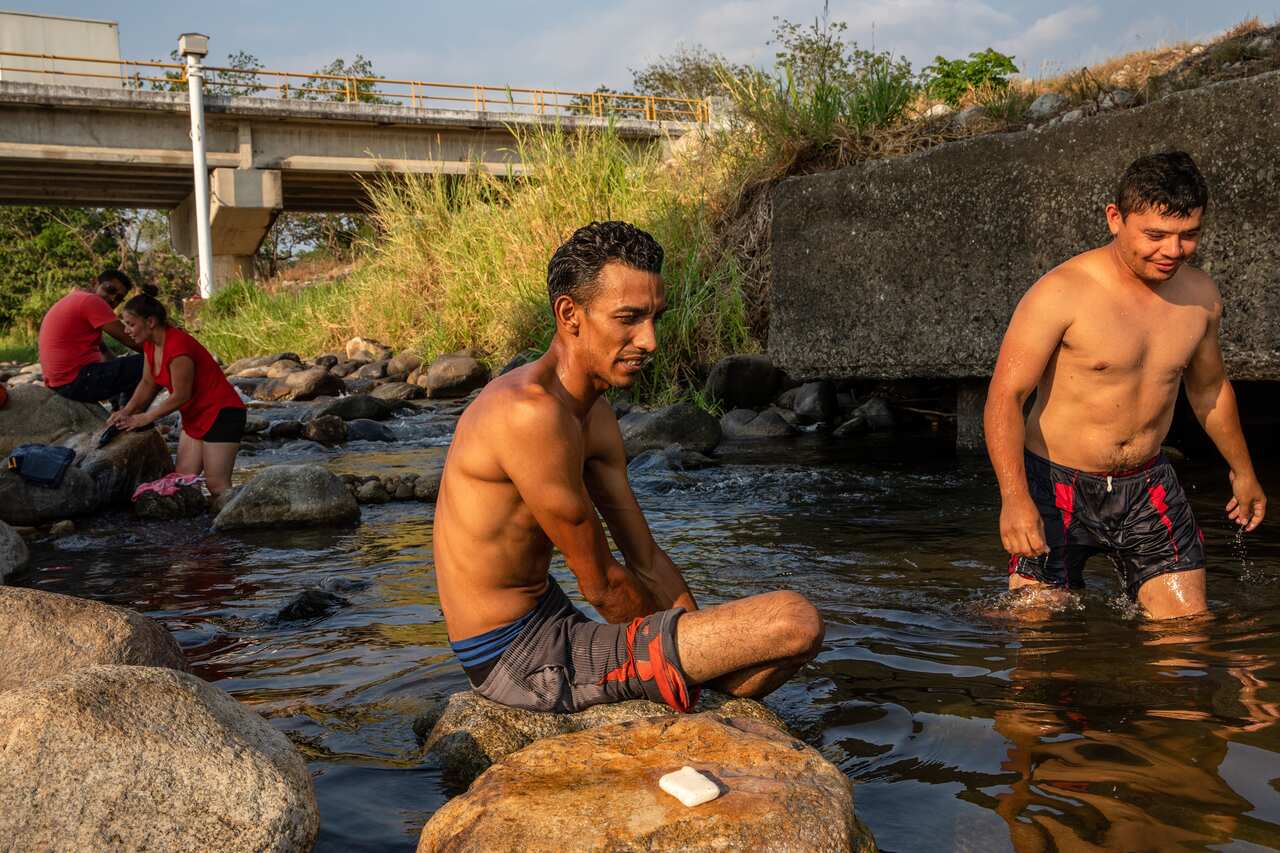 Alejandro Jos Lopez, 31, a migrant from Honduras, bathes in a river in Mapastepec, Chiapas, Mexico.