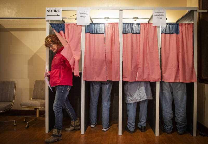 Christine Giroux exits the voting booth at Transit Town Hall after casting her vote.