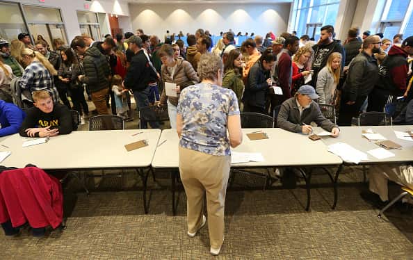 A crowd of people wait in line at a polling center in Utah.
