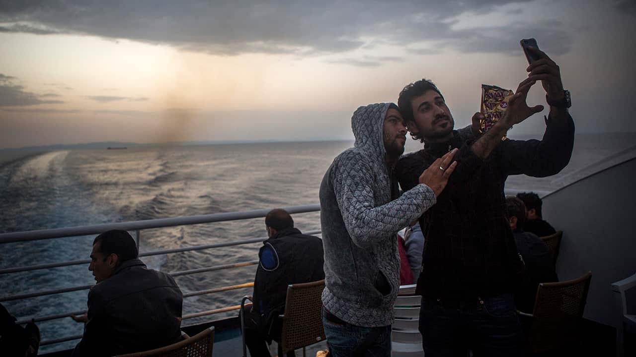 Refugees take a selfie aboard a ferry from the north eastern Greek island of Lesbos to the Athens port of Piraeus.