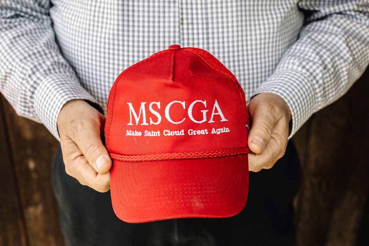 John Palmer holds a hat modeled after President Donald Trump's signature merchandise in St. Cloud, Minn., on May 16, 2019.