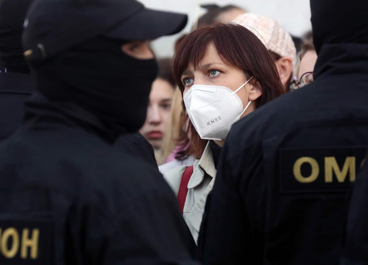 Riot police officers confront participants of the Bright March for Womens Solidarity march.
