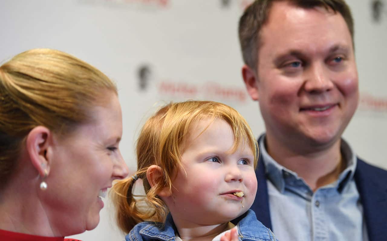Charlotte Scaife (centre) eats a Vegemite sandwich weeks after receiving surgery for a congenital heart disease.
