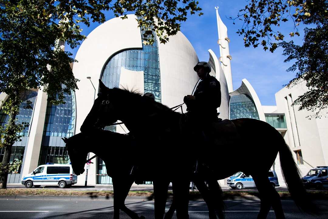 Police guard the Ditib Central Mosque, which is to be inaugurated by Turkish President Erdogan.